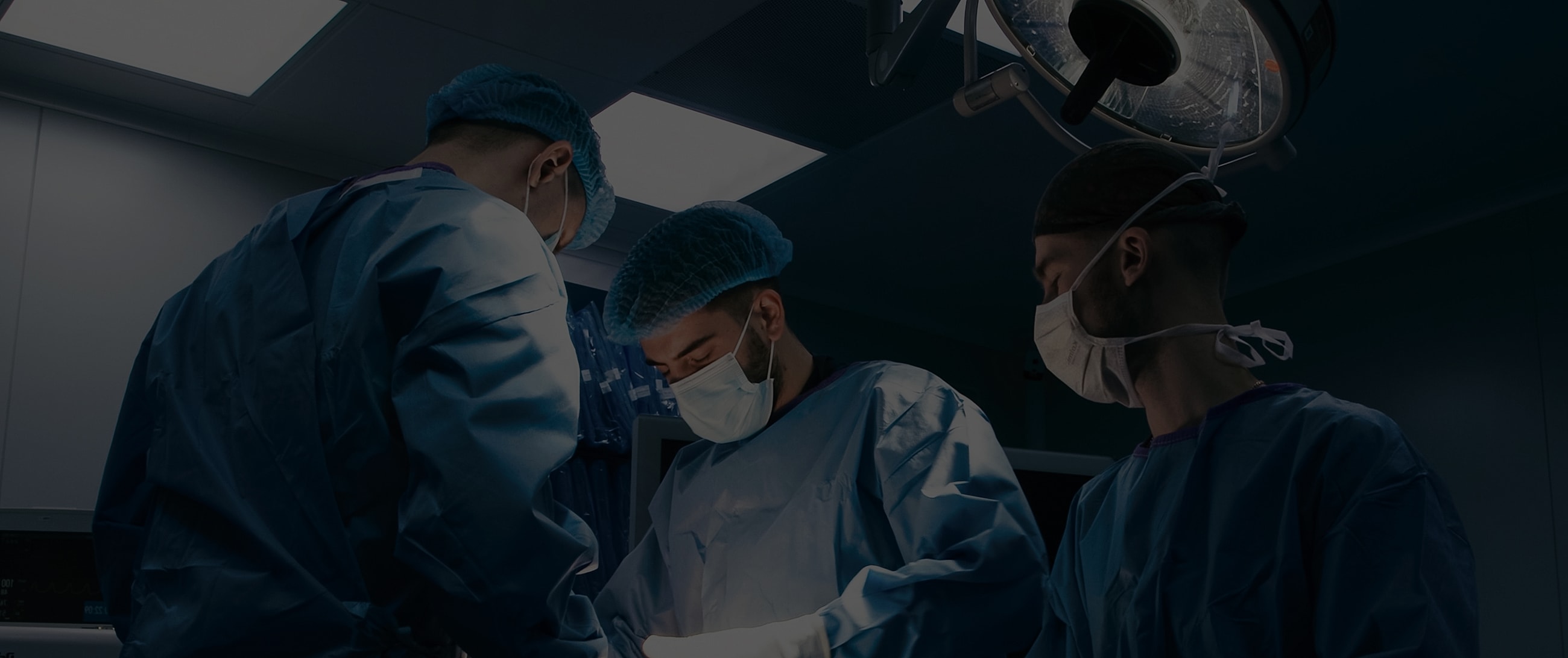 Surgeons performing a procedure in operating room.