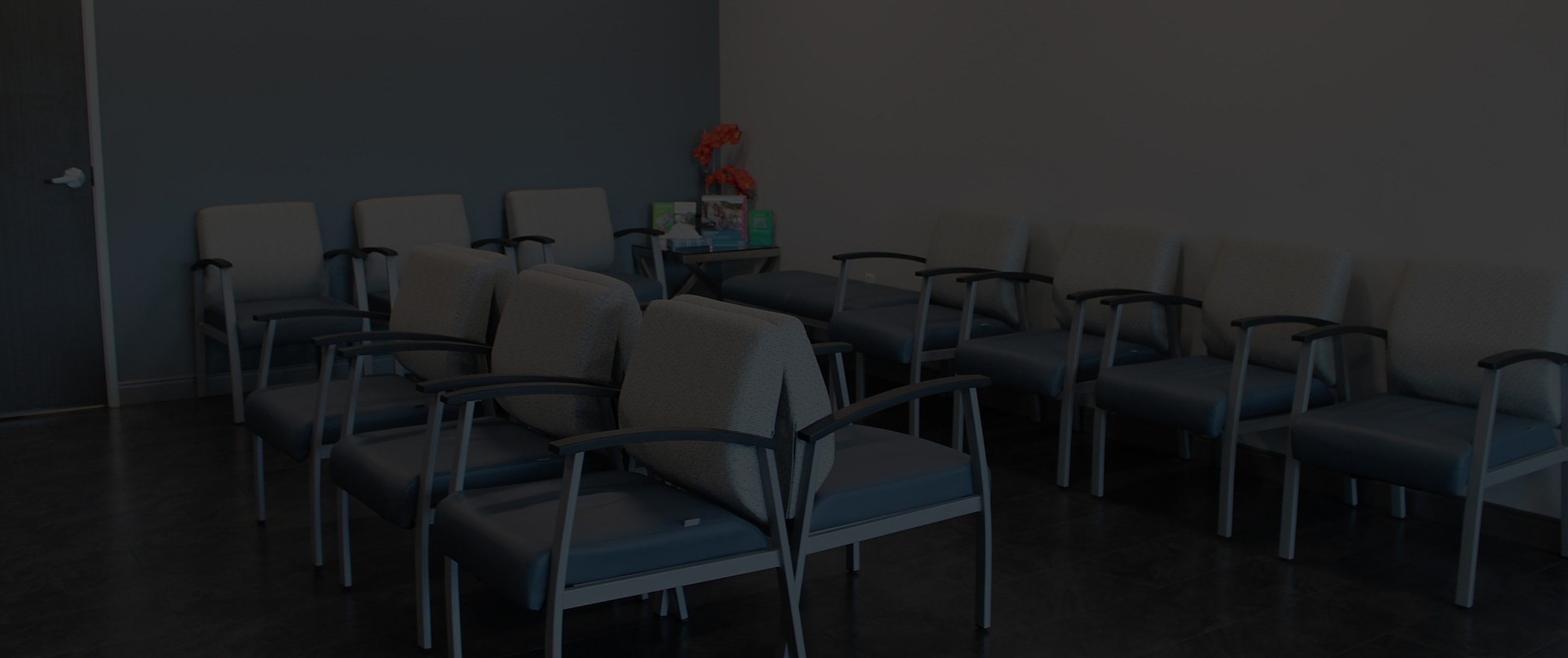 Empty waiting room with chairs and decor.