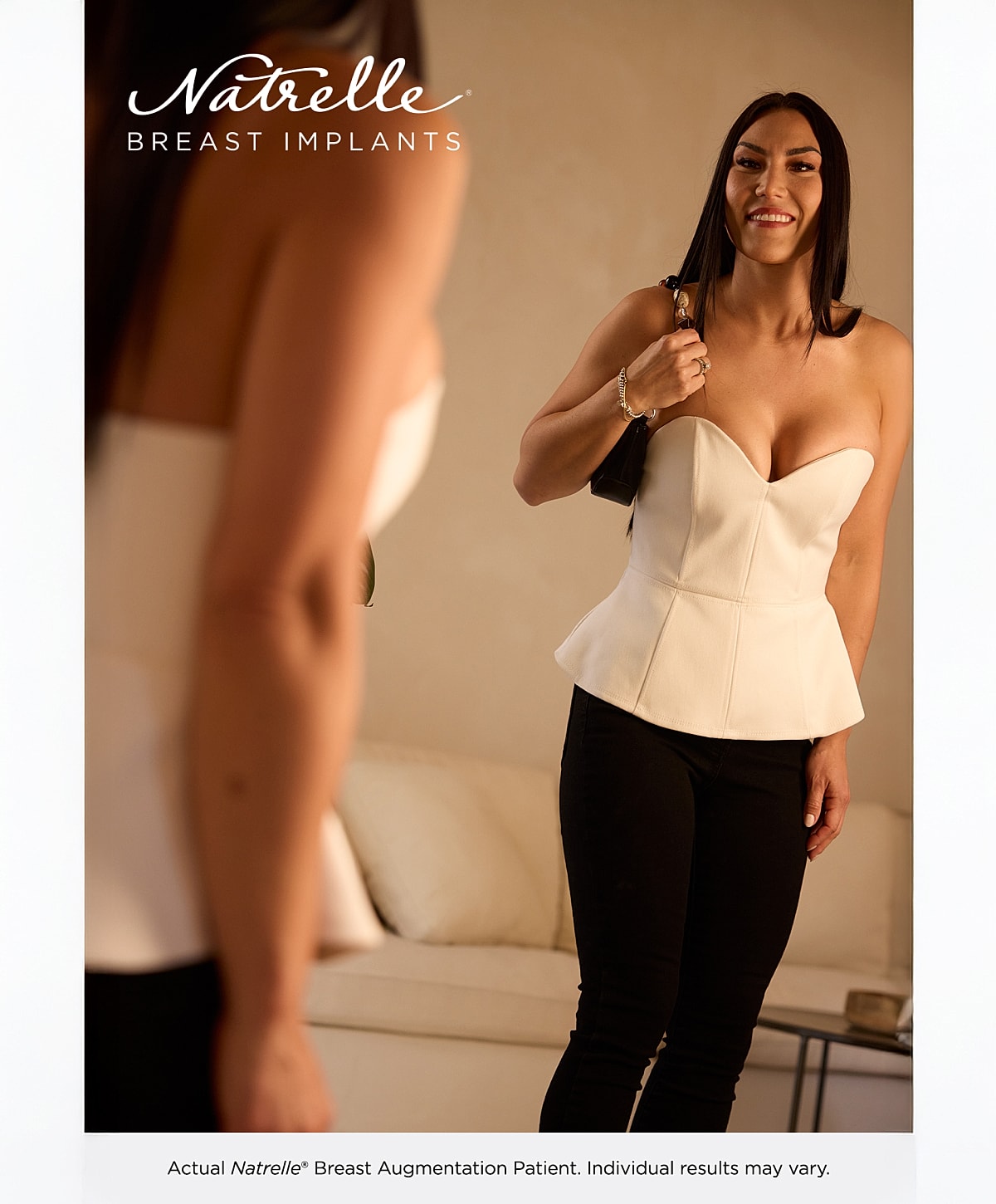 Woman in casual outfit sitting on wooden floor.