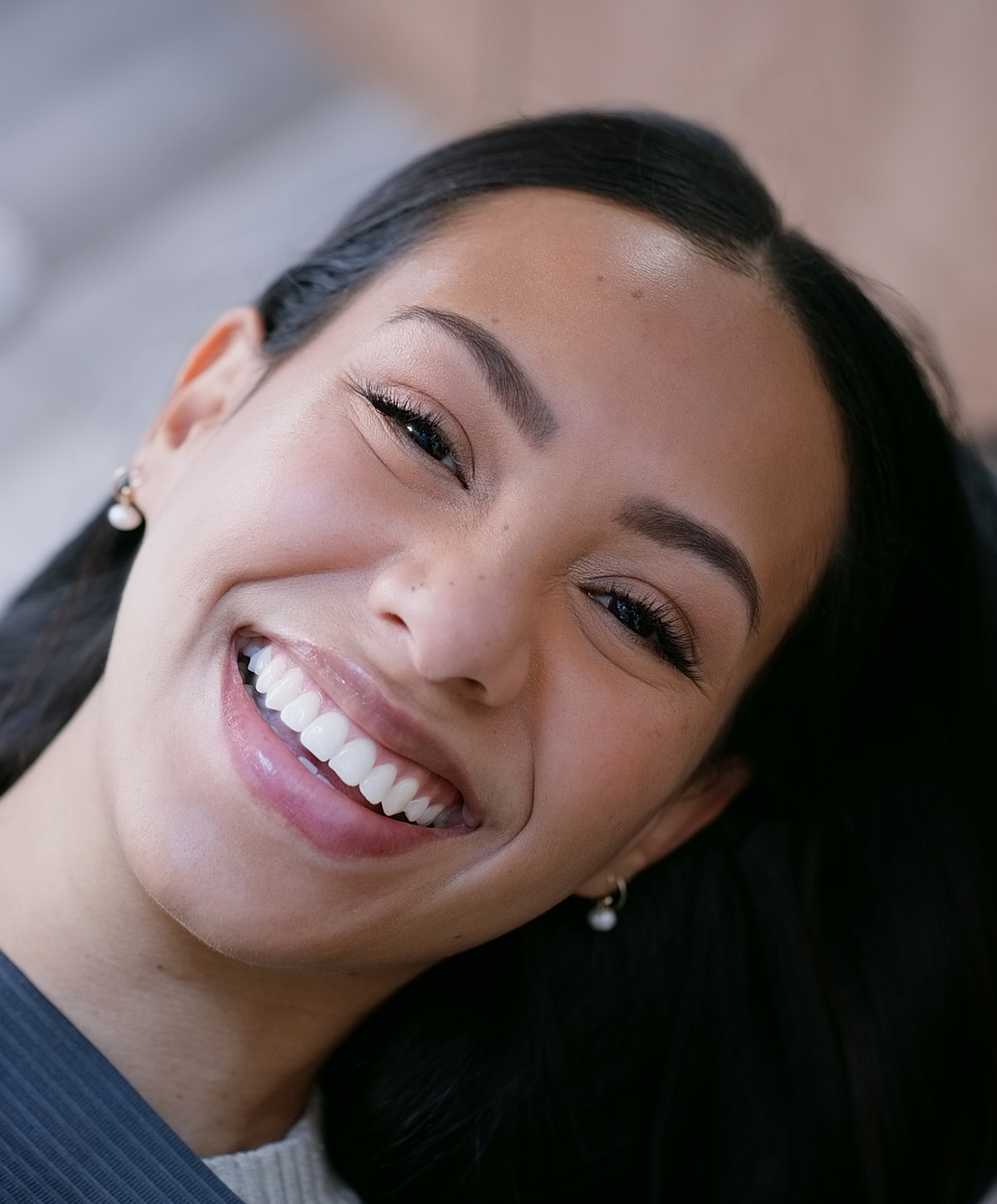 Smiling woman with long dark hair.