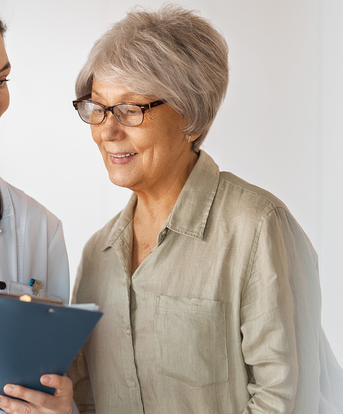 Older woman smiling while reviewing documents.