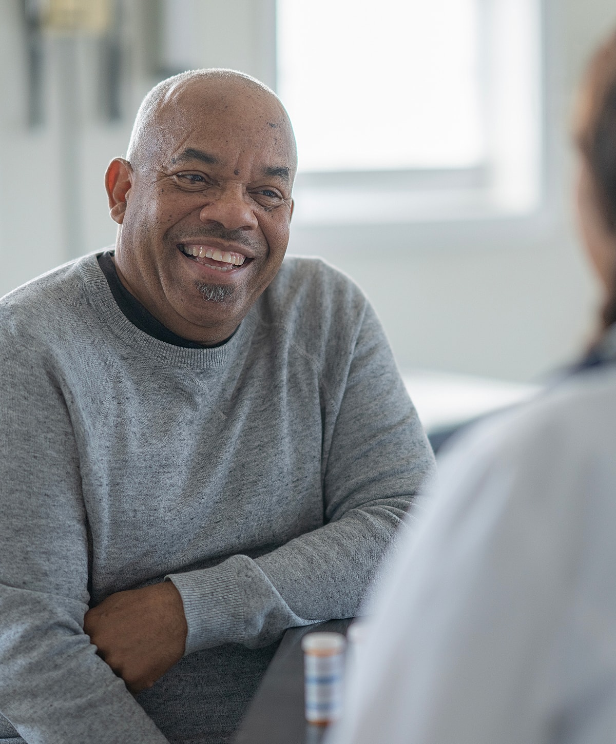Smiling man having a conversation indoors.