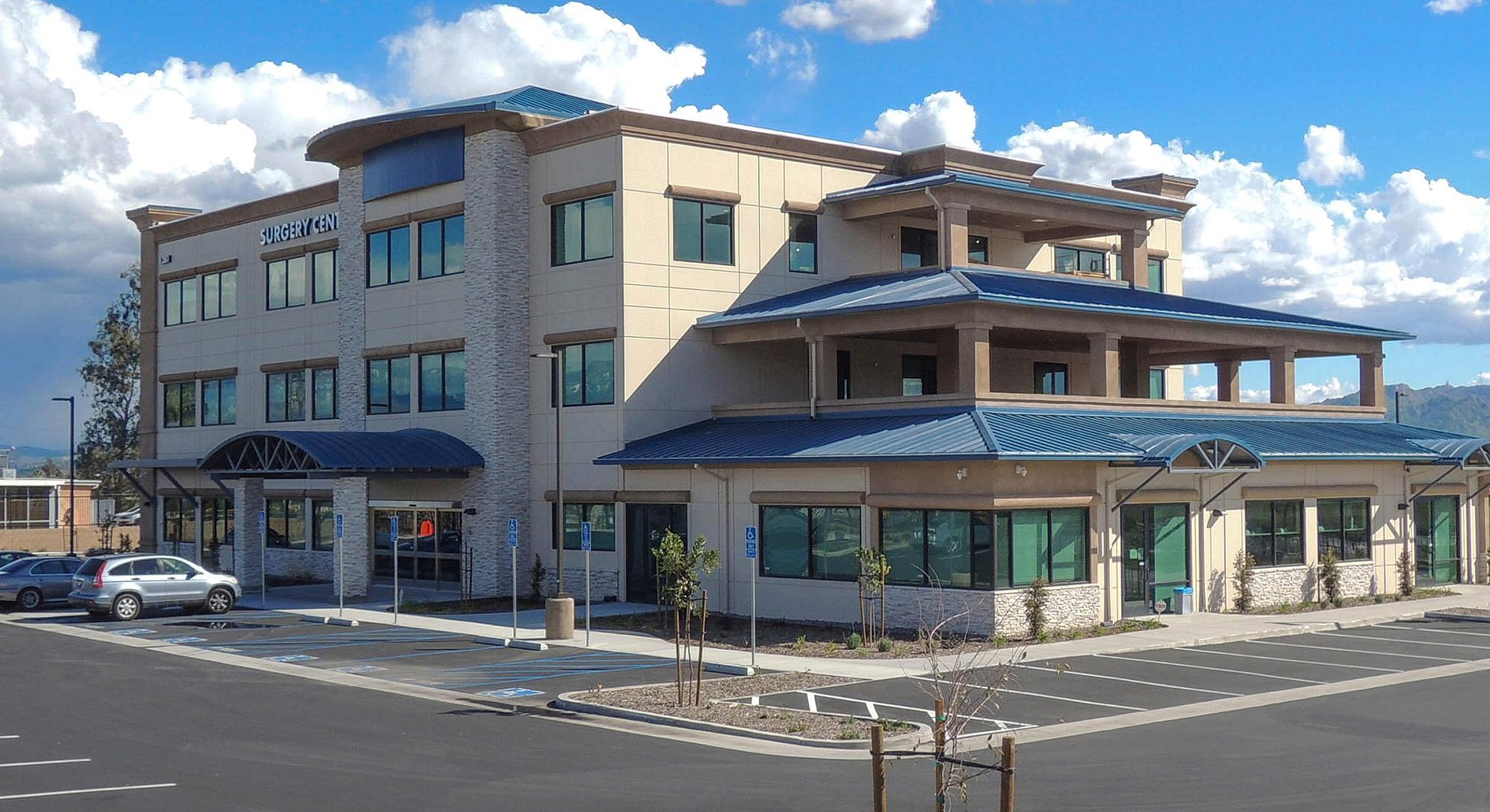 Modern surgery center building with blue roof.