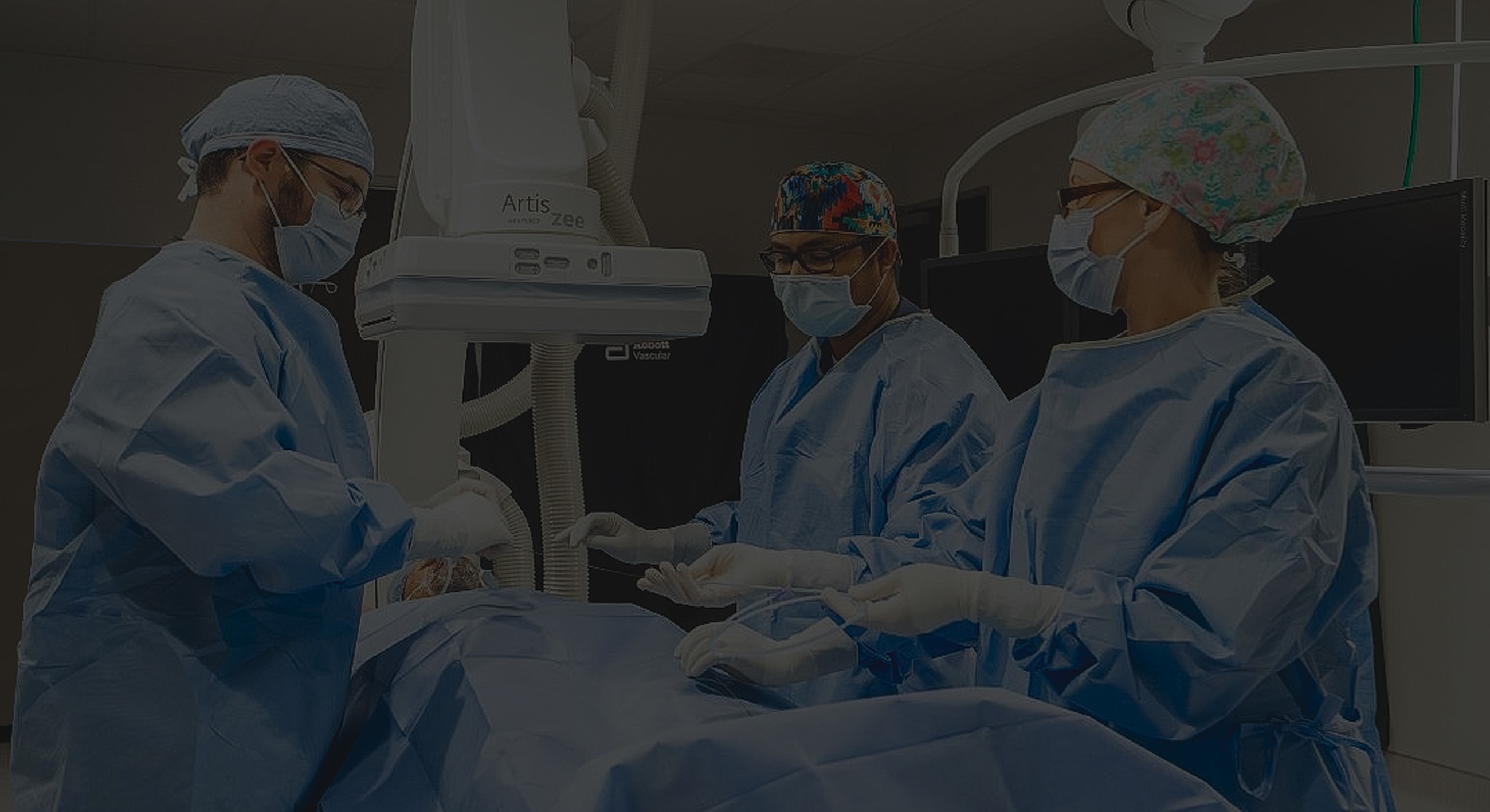 Medical team in surgery wearing protective gear.