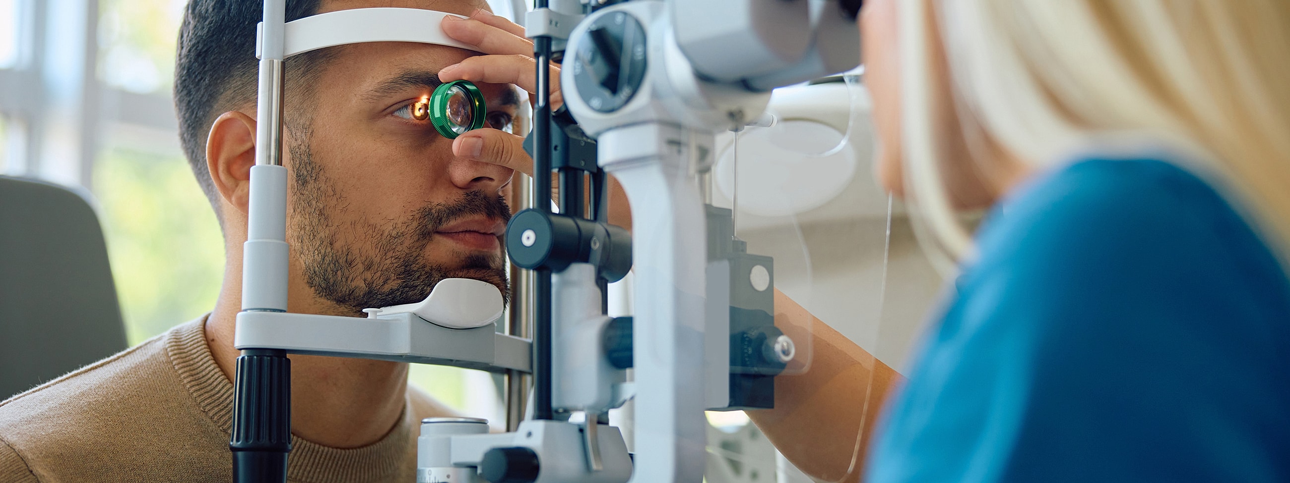 Eye examination with optometrist using specialized equipment.