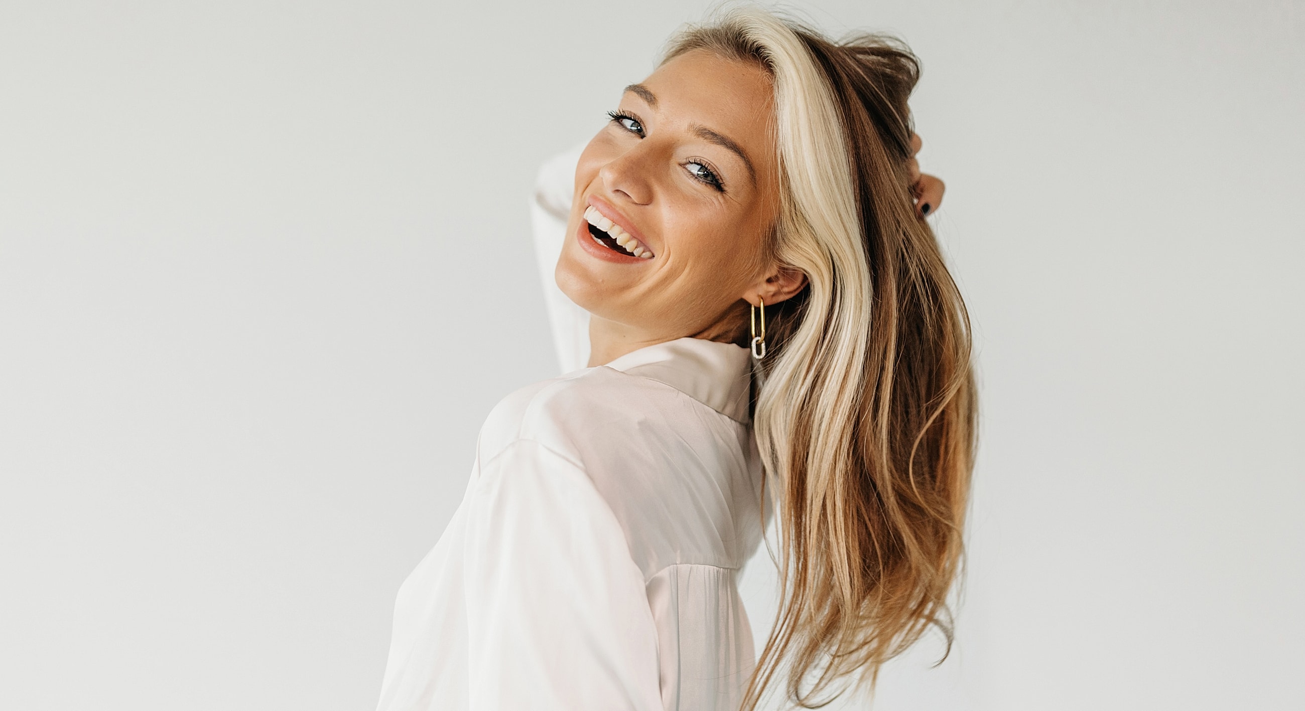 Smiling woman with long, blonde hair.
