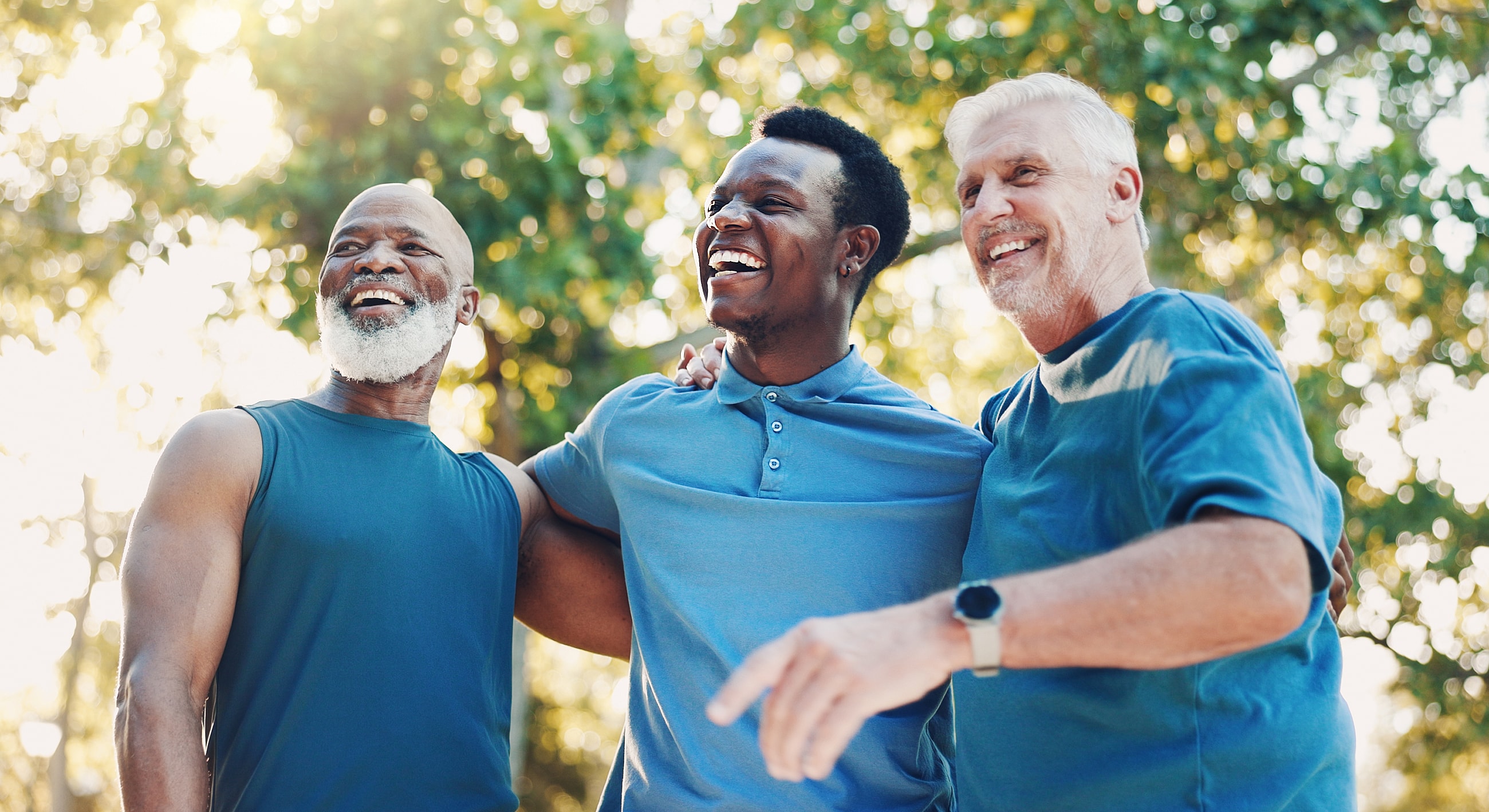Three happy men enjoying time together outdoors.