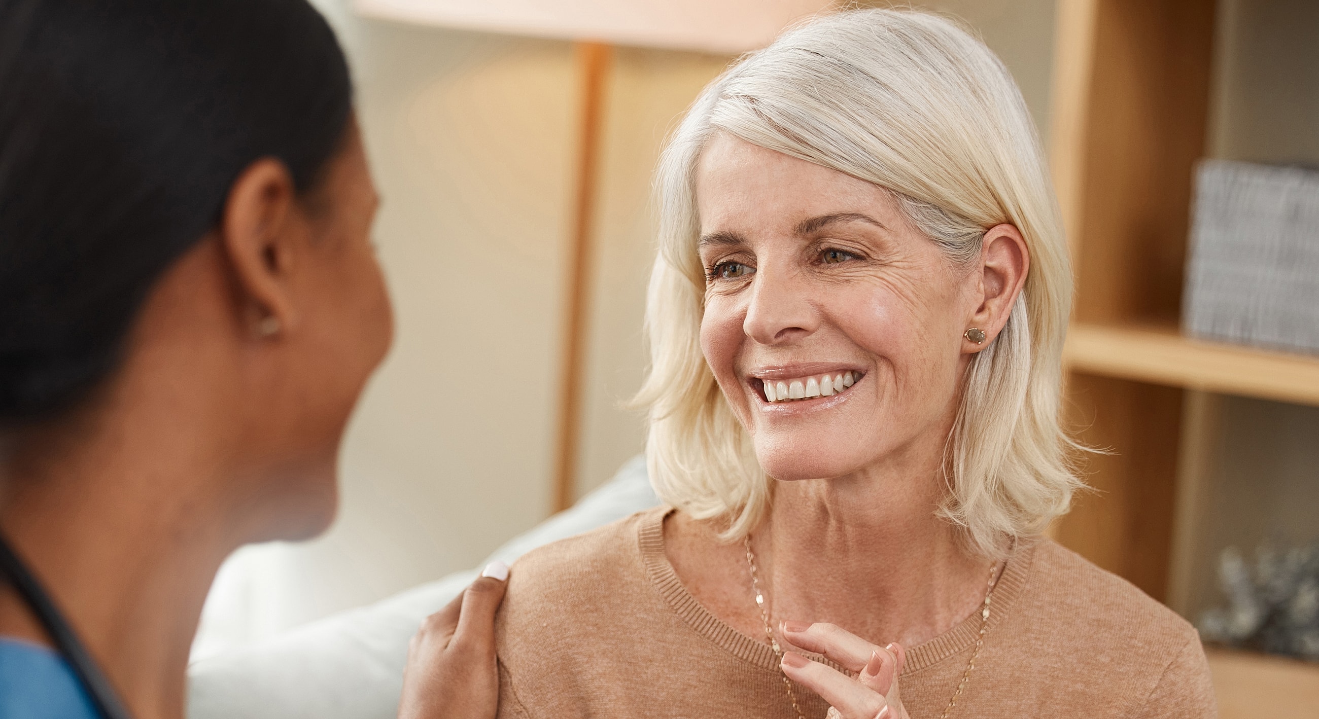 Two women sharing a warm, friendly conversation.